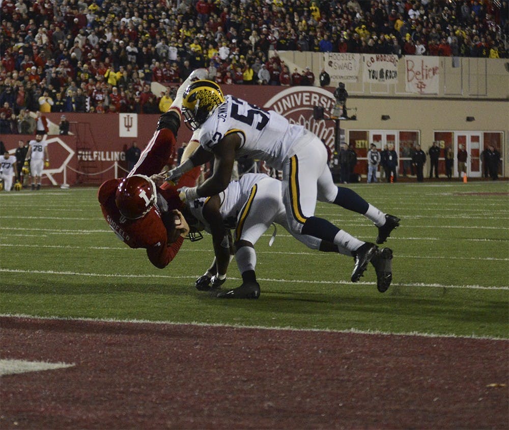 Quarterback Nate Sudfeld is tackled short of the goal line in the second overtime against Michigan on Saturday at Memorial Stadium. The Hoosiers lost in double overtime, 41-48.