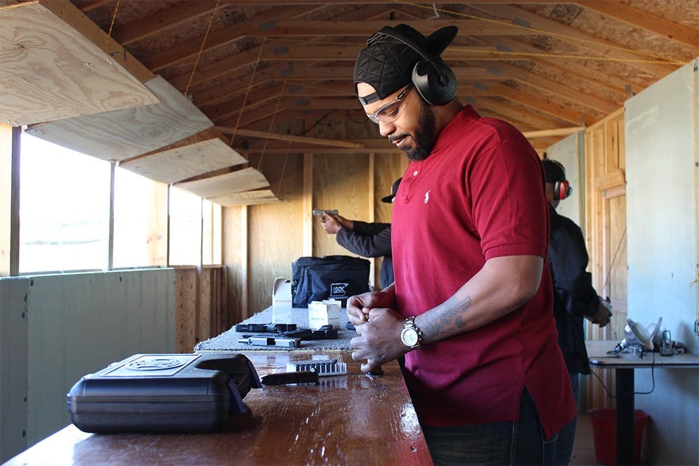 Demarcus Stewart loards a magazine for his handgun at Precision Shooting Range Saturday in Specner, Indiana. 