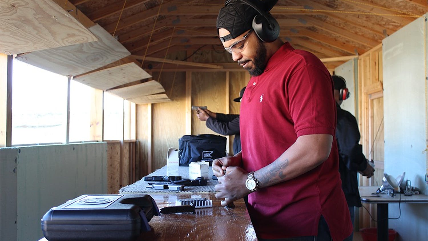 Demarcus Stewart loards a magazine for his handgun at Precision Shooting Range Saturday in Specner, Indiana.