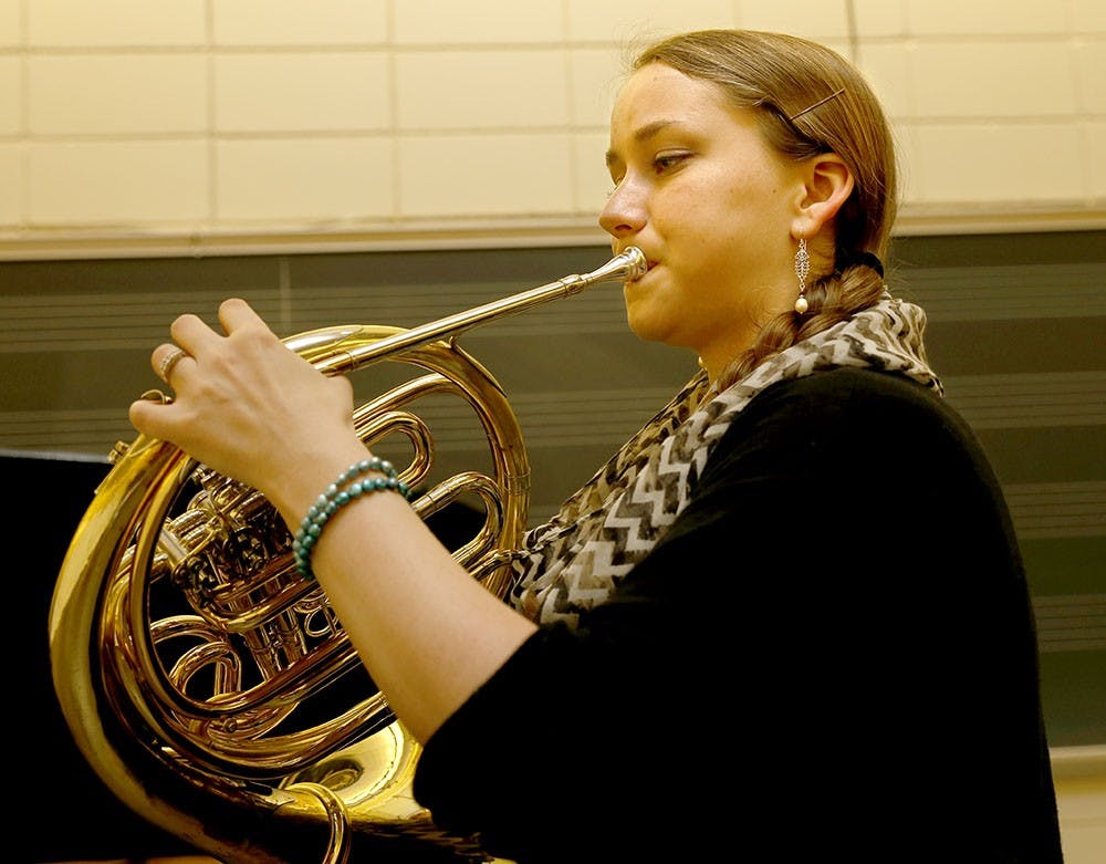 Kristen Fowler practices the French horn for her master's recital Wednesday at the Musical Arts Center room 040. Fowler will perform the recital based on her sexual assualt experience.  