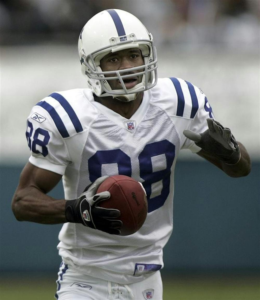 In this Dec. 11, 2005, file photo, Indianapolis Colts receiver Marvin Harrison scores a touchdown against the Jacksonville Jaguars in an NFL football game in Jacksonville, Fla. Harrison's reluctance to take a pay cut could mark the end of his career in Indianapolis.