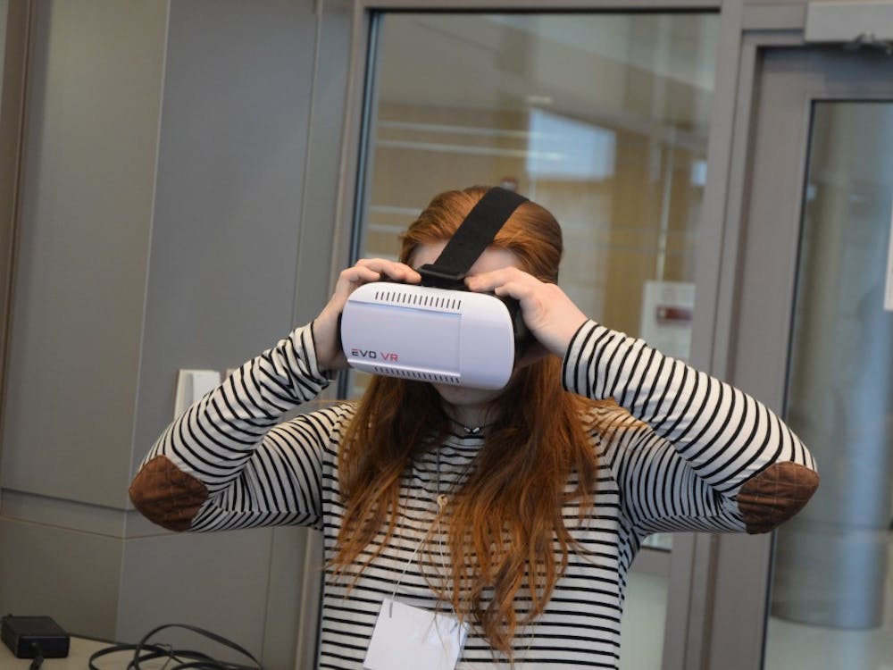 Freshman Faith Frazer tries on a Virtual Reality headset during the CEWiT Summit in Union Street Center. The Summit took place March 23 and 24 and was open for IU students and community members.