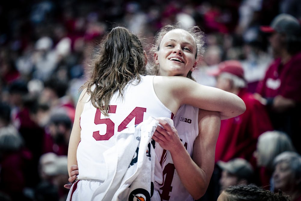 Senior Mackenzie Holmes and senior Grace Berger hug during the final seconds Feb. 19, 2023, at Simon Skjodt Assembly Hall. Holmes and Berger were recognized by the Associated Press All-America team on Wednesday.