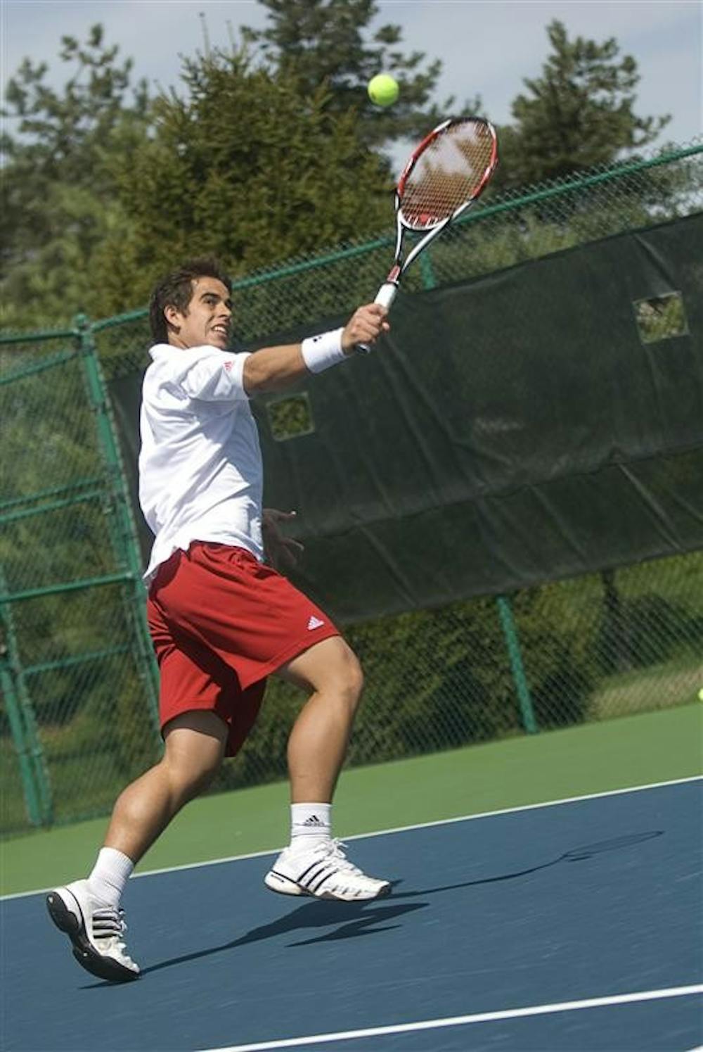 IU sophomore Santiago Gruter hits a backhand during a doubles match against opponents Penn State on Sunday afternoon at the Outdoor Tennis Courts. He and doubles partner freshman Jeremy Langer lost their match 8-5.