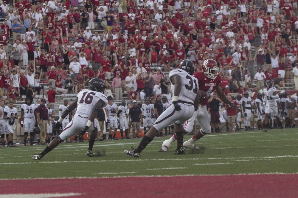 Wide receiver Ricky Jones moves to escape SIU players Andrew McCrea and Kenny James in the fourth quarter of the game on Saturday at Memorial Stadium. The Hoosiers beat the Salukis 48-47.