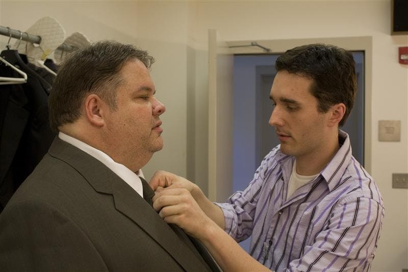Costume designer Scott Anderson makes the finishing touches to a charactor in the play "Dead Man Walking." The suit makes the man and as Scott says, "a wrinkle in a tie shows your class."