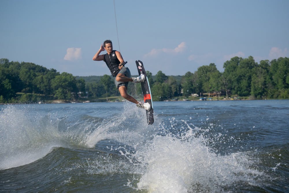 <p>IU senior Jacob Torres makes a move in the air Aug. 22, 2021, at Lake Lemon in Unionville, Indiana. Waterski and Wakeboard Club has cultivated a positive image around campus and is well known for its free spirits and enthusiasm.</p>