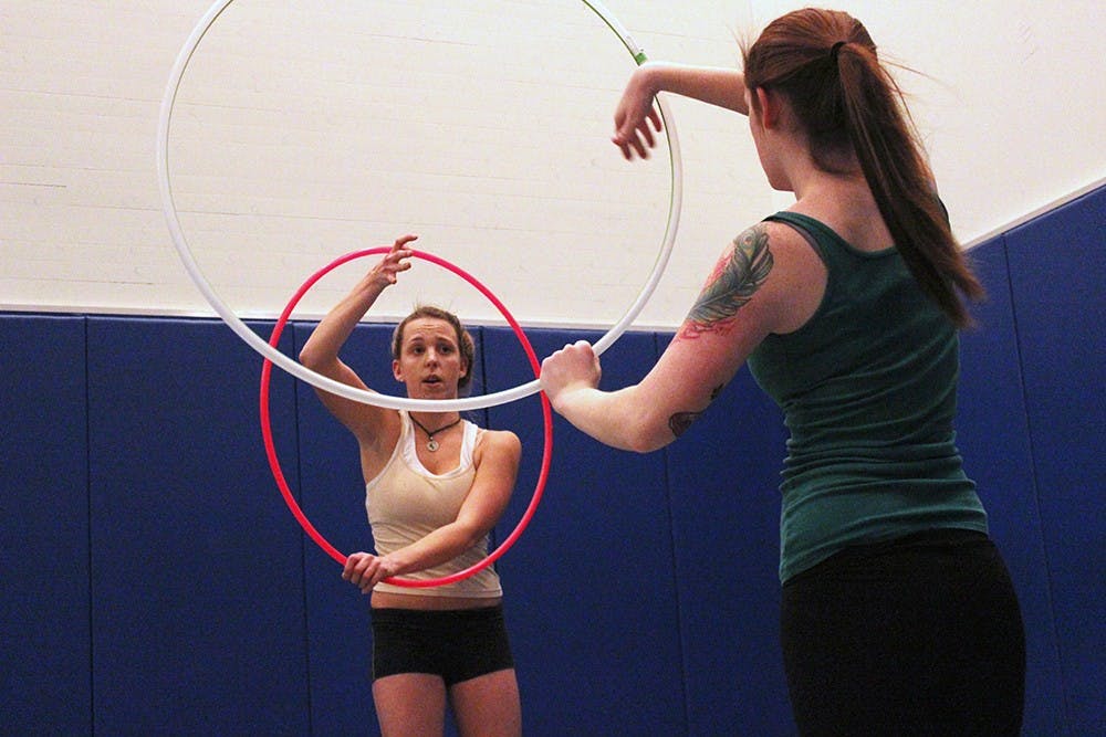 Members of the Flow Club practice their hooping tricks at the Wildermuth Intramural Center on Wednesday evening. Flow Club isn't yet an IU student organization, but is in the works to become official next semester. 