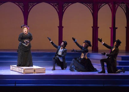 Darian Clonts, Anna Farley and Jeremy Weiss pose as Tiffany Choe stands on suitcases to sing in "L'étoile." The opera will play at the Musical Arts Center at 7:30 p.m. on Oct. 13, 14, 20 and 21.