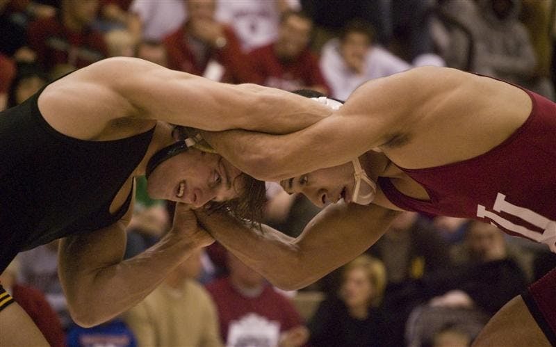 No. 2 Alex Tsirtsis of Iowa wrestles against IU's Andrae Hernandez in the 141-pound weight class Friday evening at the University Gym. Hernandez pulled off the upset, handing Tsirtsis his third loss on the year.