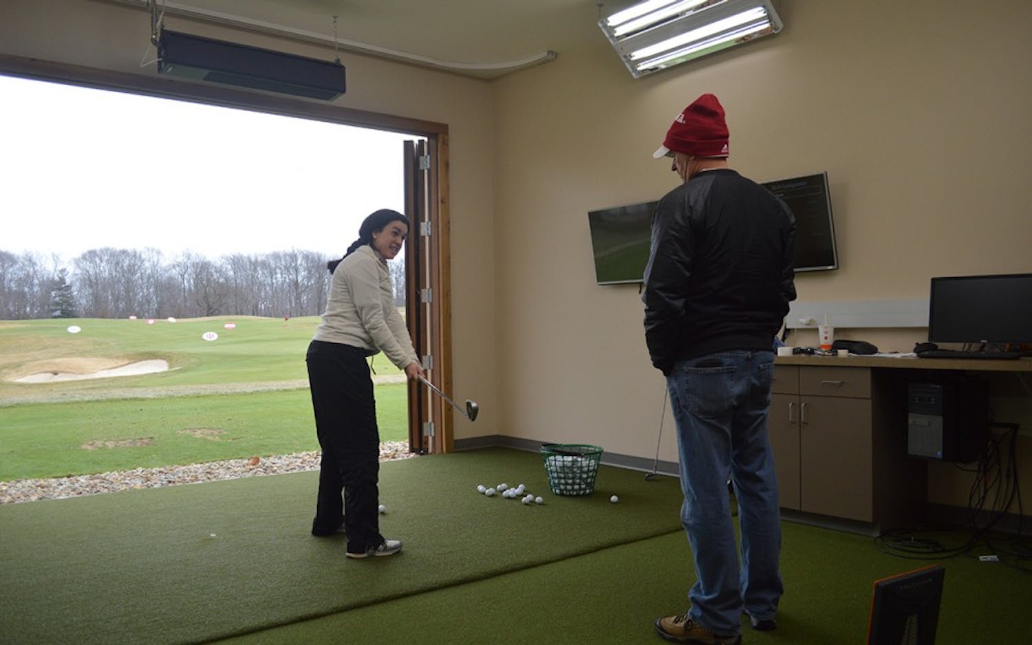 Senior Ana Sanjuan worked on her swing with IU Coach Clint Wallman during an individual training session in early February. Sanjuan and the Hoosiers are traveling to Arizona this weekend for their first tournament of the season.&nbsp;