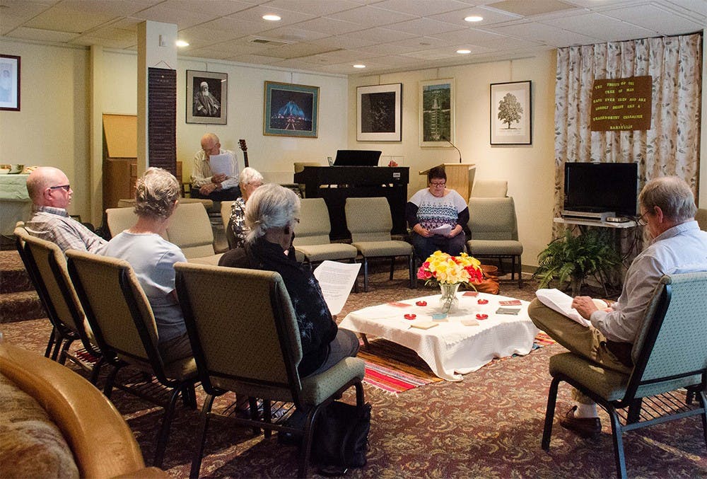 Members of the Bahá’í Faith community of Bloomington read passages during an interfaith devotional time Sunday.