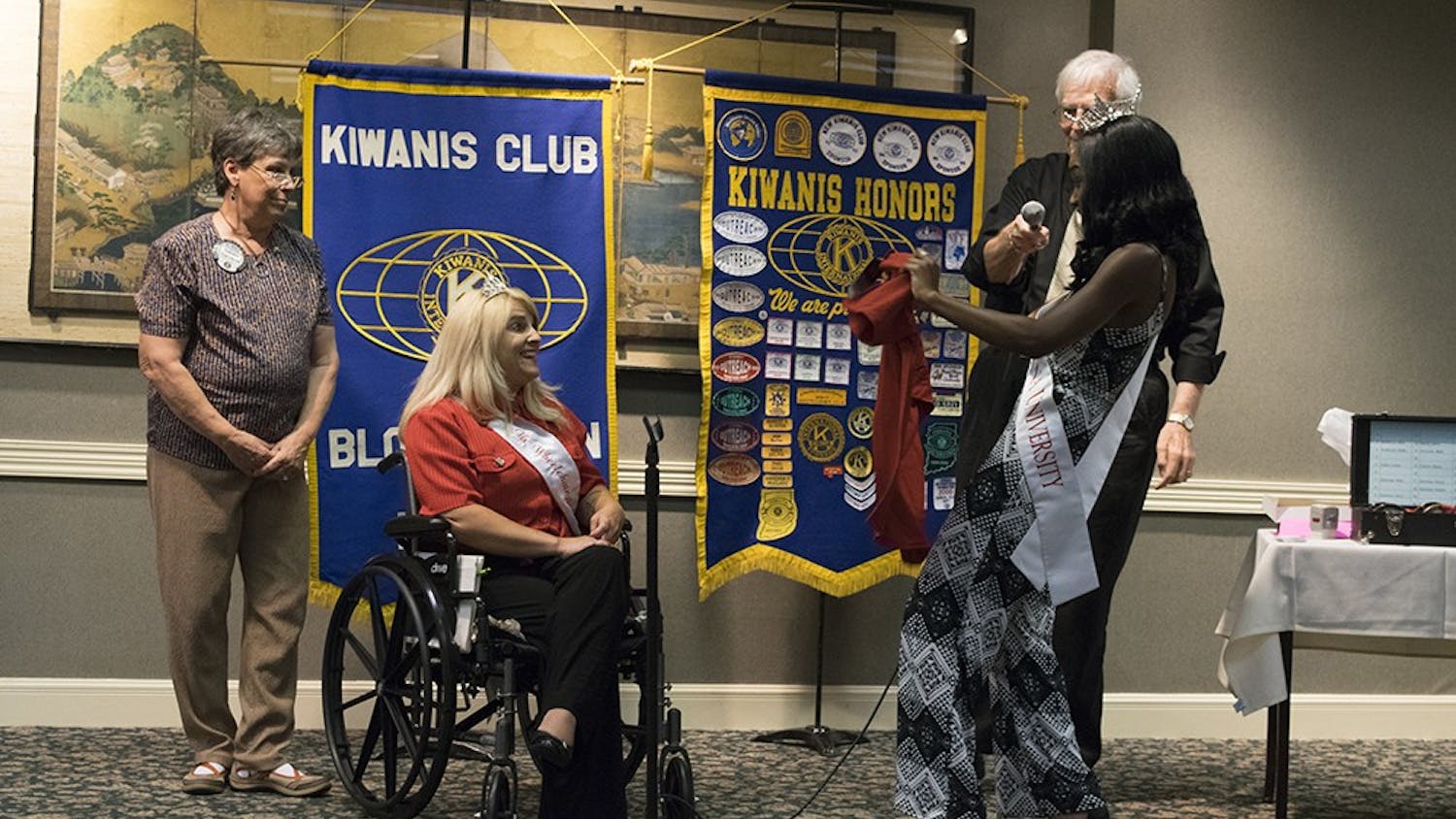 A’Niyah Birdsong, Miss Indiana University 2017,  presents an IU t-shirt to Lesamarie Hacker, Ms. Wheelchair of Indiana. Hacker spoke to the Kiwanis Club of Bloomington on Thursday.