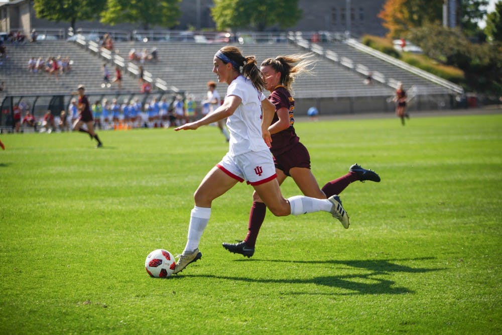 <p>Senior Abby Allen moves the ball down the field and tries to keep it away from junior Marisa Windingstad on Oct. 7 at Bill Armstrong Stadium. IU defeated Minnesota, 3-2.</p>