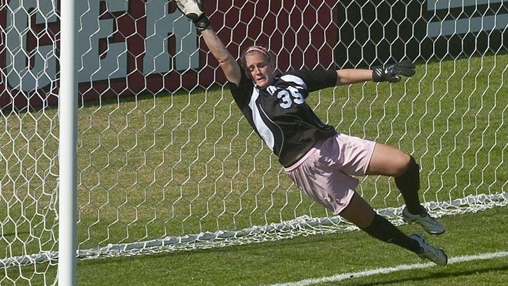 Freshman goalkeeper Shannon Flower attempts a save during IU's loss to Michigan on Sunday at Bill Armstrong Stadium. The ball went wide and didn't actually go into the net. 