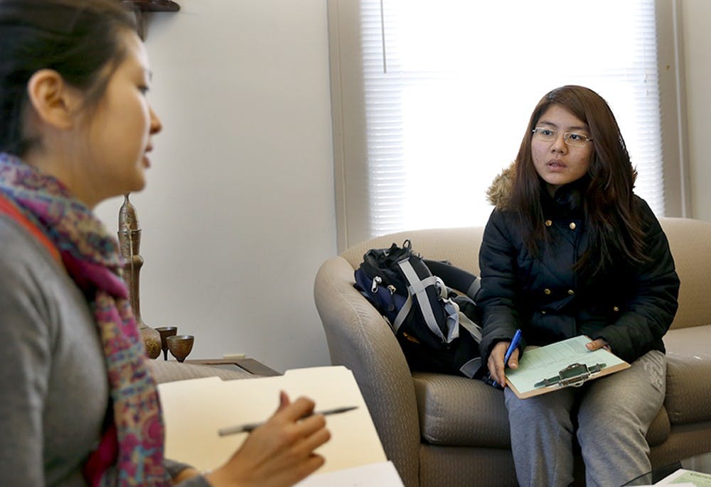 Sarah Stamey, left, program associate, tells freshman Tang Mawi what role of a tutor is during a tutor orientation Tuesday at the Asian Culture Center. The Asian Culture Center has "English Tutoring / Peer Support" program every semester to help international students for peer papers and cultural adjustment by student volunteers. 