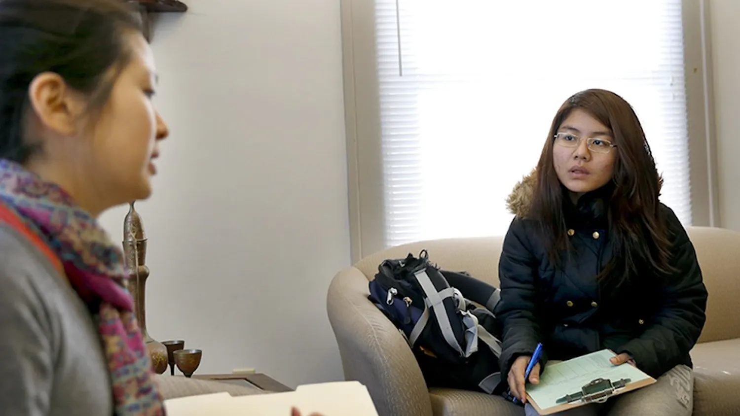 Sarah Stamey, left, program associate, tells freshman Tang Mawi what role of a tutor is during a tutor orientation Tuesday at the Asian Culture Center. The Asian Culture Center has "English Tutoring / Peer Support" program every semester to help international students for peer papers and cultural adjustment by student volunteers.