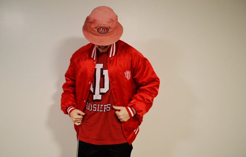 <p>A student shows off his IU gear from Hoosier A1 Vintage, a clothing store created by seniors Trey Humphrey and Sam Crawford. Humphrey originally got into thrifting to save money on clothes.﻿</p>
