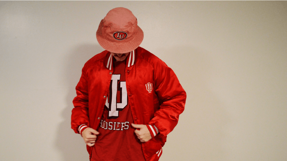 A student shows off his IU gear from Hoosier A1 Vintage, a clothing store created by seniors Trey Humphrey and Sam Crawford. Humphrey originally got into thrifting to save money on clothes.﻿