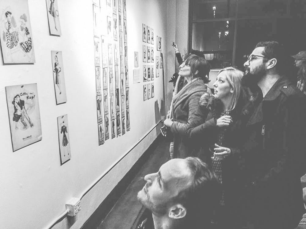 Audiences watch Geraldine McFadin's fashion sketches from the 1940s to the 1980s during the "Fashion and Fairy Tales" event on Mar. 4 at the Blueline Gallery. The show will be displayed until Apr. 29. 