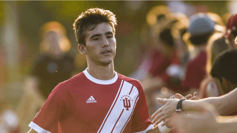 Freshman Joshua Penn high-fives fans prior to the start ofIU&#x27;s match against the University of Notre Dame on Sept. 17 at Bill Armstrong Stadium. IU will play Wisconsin on Sept. 20 in Bloomington.