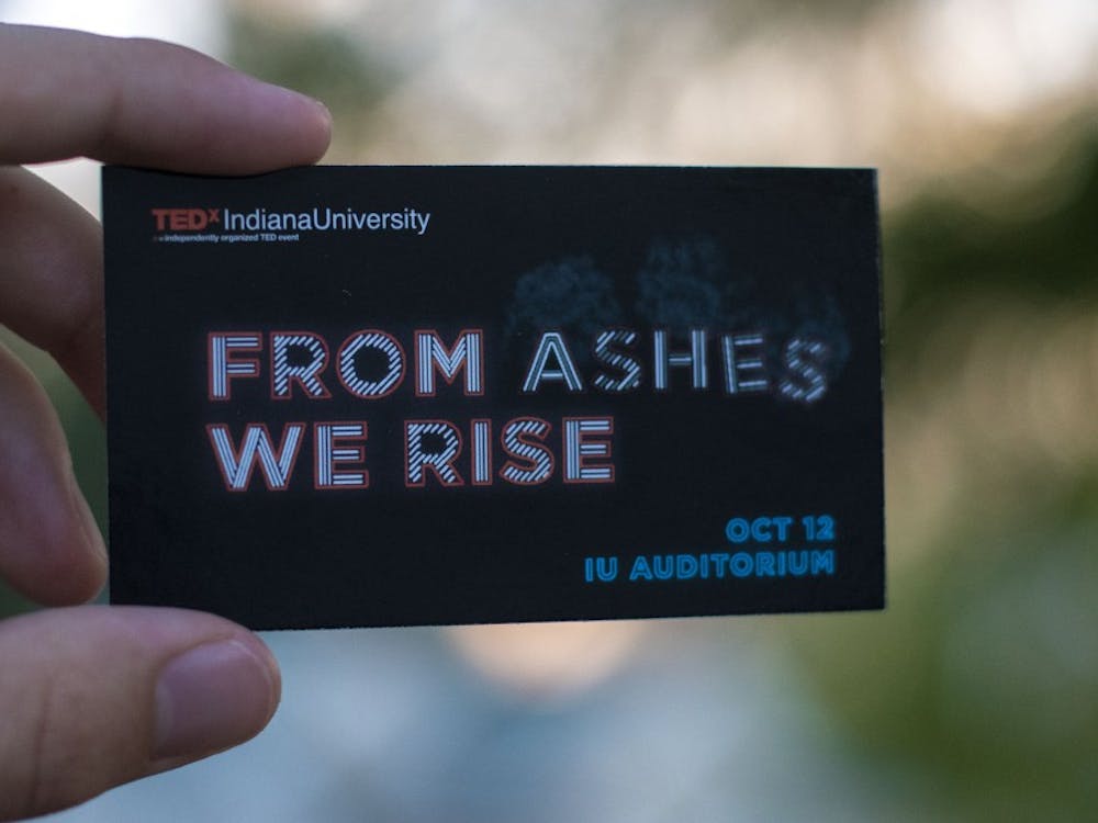A student holds an information card for an upcoming TEDxIU event. The event is titled “From Ashes We Rise” and will take place Oct. 12 in the IU Auditorium.