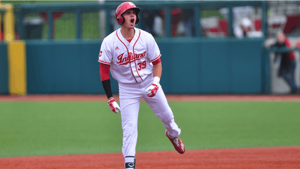 Senior Craig Dedelow celebrates his RBI double at second base, which would ultimately be the Hoosiers’ only run in a 3-1 loss to Nebraska.