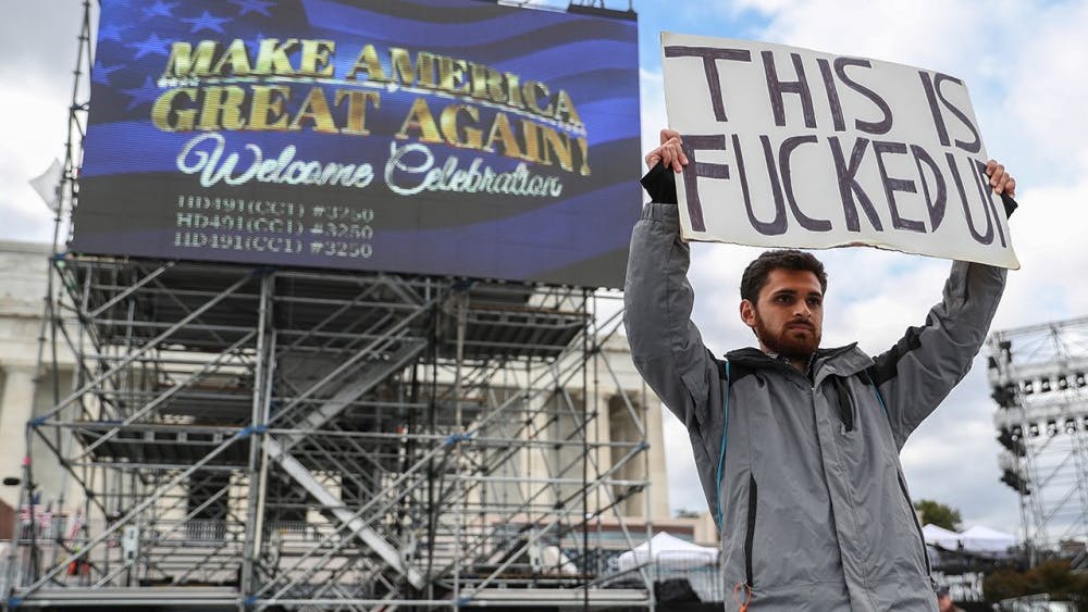 Kieran Mclean stands in front of the Lincoln Memorial protesting Donald Trump's "Welcome Celebration" on January 18, 2017. The celebration will take place at the National Mall in front of the memorial after the swearing in ceremony this coming Friday. Headliner Toby Keith will perform along with numerous guest speakers. 