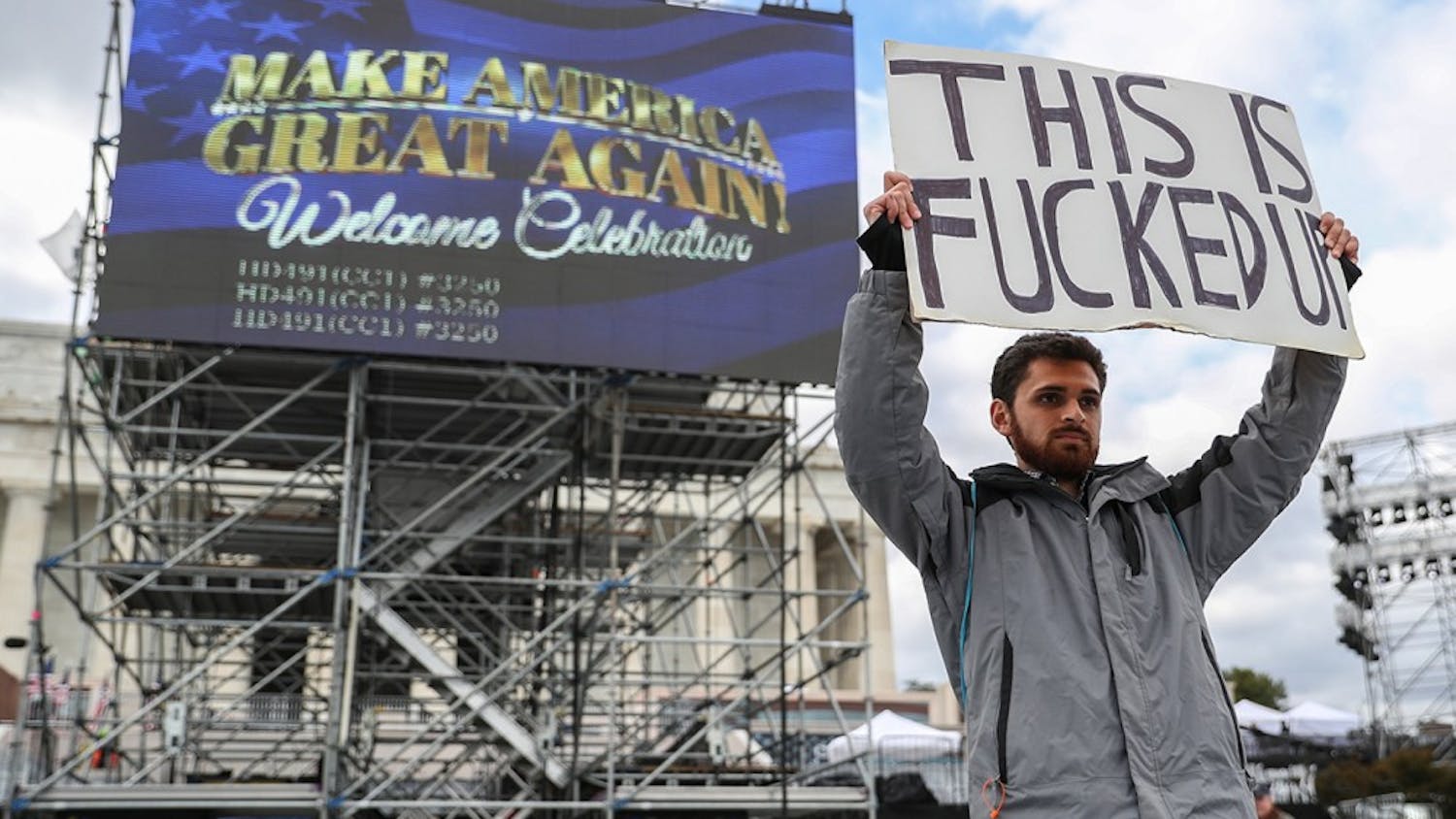 Kieran Mclean stands in front of the Lincoln Memorial protesting Donald Trump's "Welcome Celebration" on January 18, 2017. The celebration will take place at the National Mall in front of the memorial after the swearing in ceremony this coming Friday. Headliner Toby Keith will perform along with numerous guest speakers. 