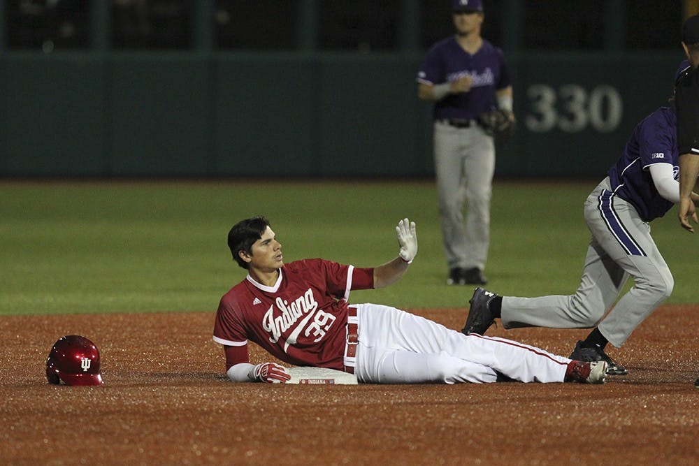 Junior outfielder Craig Dedelow slides into second in the eighth inning of play against Northwestern on Friday night. Dedelow's hit brought Alex Krupa home and brought the score to 3-2 with Northwestern winning, but the Hoosiers got one more run in the eighth and another in the ninth to win.