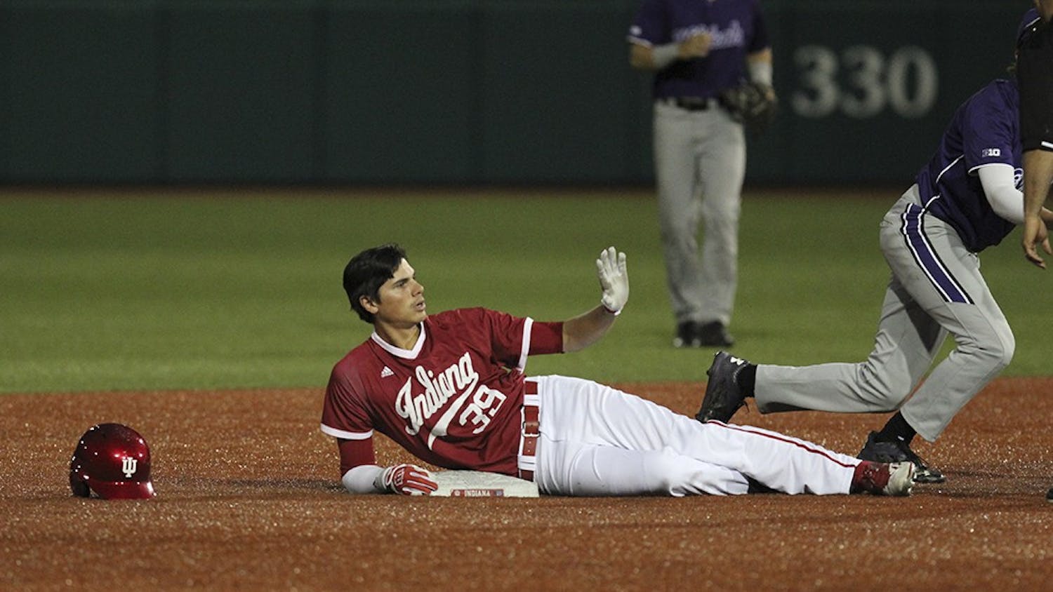 Junior outfielder Craig Dedelow slides into second in the eighth inning of play against Northwestern on Friday night. Dedelow's hit brought Alex Krupa home and brought the score to 3-2 with Northwestern winning, but the Hoosiers got one more run in the eighth and another in the ninth to win.