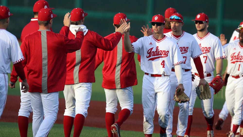 The IU baseball team high-fives March 4, 2022, at Bart Kaufman Field. The Hoosiers went 1-2 in their opening series against Auburn University over the weekend.
