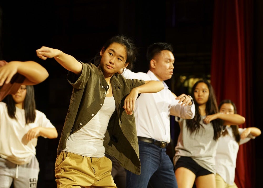 <p>The Vietnamese Student Association performs a dance routine for judges and spectators during the World’s Fare Friday evening in Alumni Hall. The event was a part of International Education Week and featured international cuisine, booths hosted by student organizations and a special international themed IMU Late Nite hosted afterwards.</p>