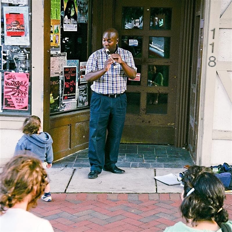 Jay Dowl plays the recorder while Kanase, Zak and Hagino Hargis listen Saturday afternoon outside the old Greek's Pizzeria on Kirkwood Avenue. Dowl has playedthe recorder for 12 years, and performed many various pieces, including classical songs from various composers.