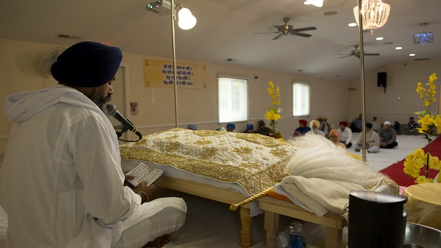 A Sikh priest reading out passages from the Guru Granth Sahib, a Holy Book, to a congregation in Fishers, Ind.