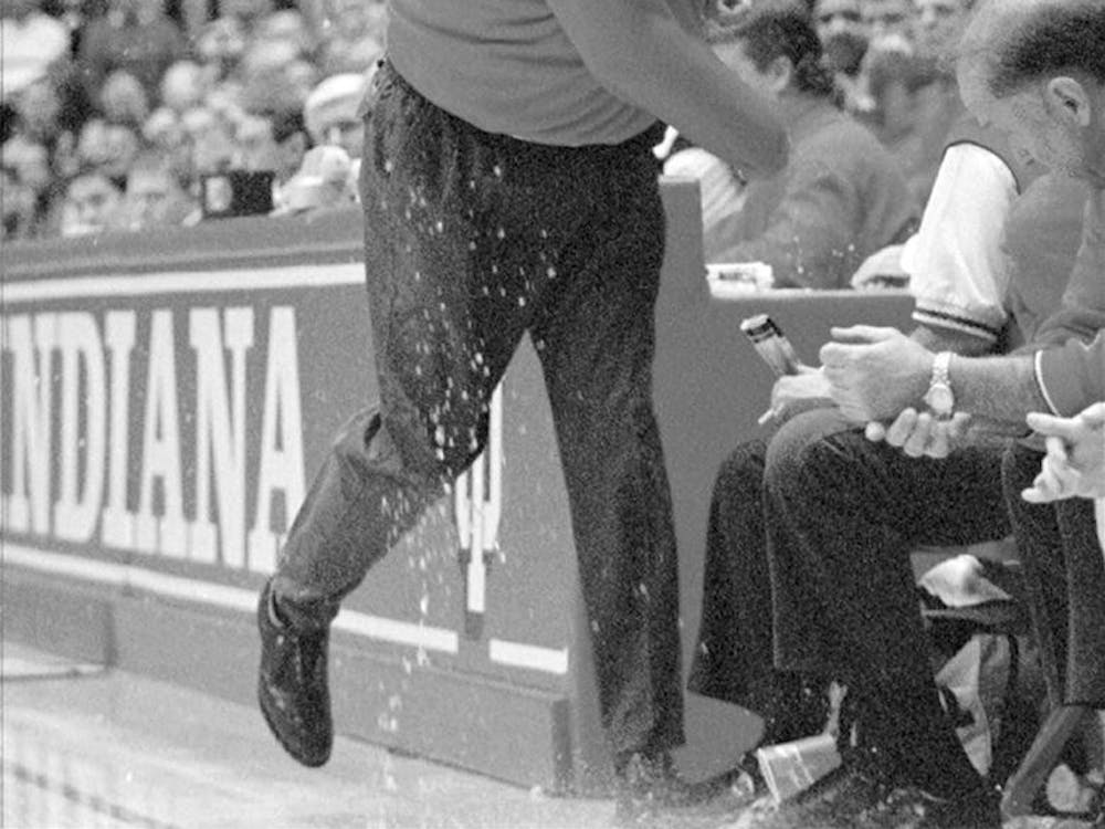 Indiana coach Bobby Knight throws a cup of water onto the floor in the first half of a 1997 IU v. Minnesota game in Bloomington.  