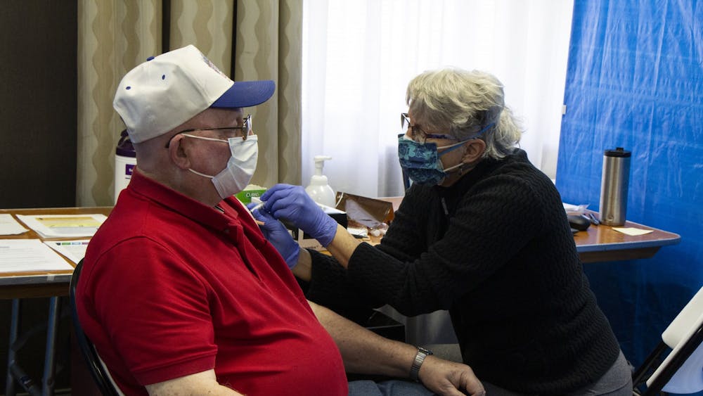 Nurse Cathy Green gives Raymond Lamar their second dose of the Moderna COVID-19 vaccine Feb. 24 at the Monroe Convention Center. Monroe County Health Department administrator Penny Caudill said the clinic distributes about 800 doses a week. 