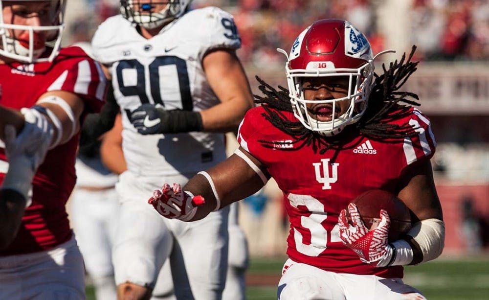 Junior running back Devine Redding runs the ball into score for Indiana during the second quarter of play against Penn State.
