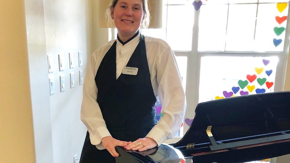Jaclyn Klinger, a server at Northridge Gracious Retirement Living, poses for a photo. Klinger has temporarily moved into the facility due to the coronavirus pandemic. 