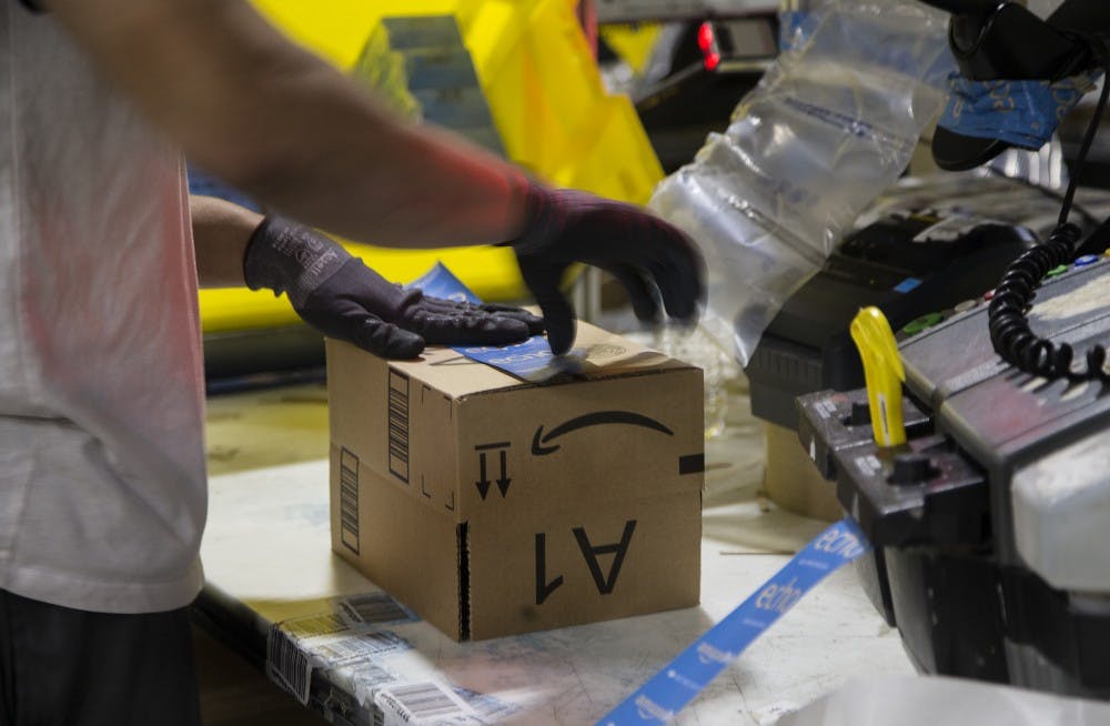 <p>A worker tapes a box while packing items on Cyber Monday at the Amazon Fulfillment Center in San Bernardino, California. Indianapolis is a finalist among 19 other cities for Amazon's second headquarters in North America, known as Amazon HQ2.</p>