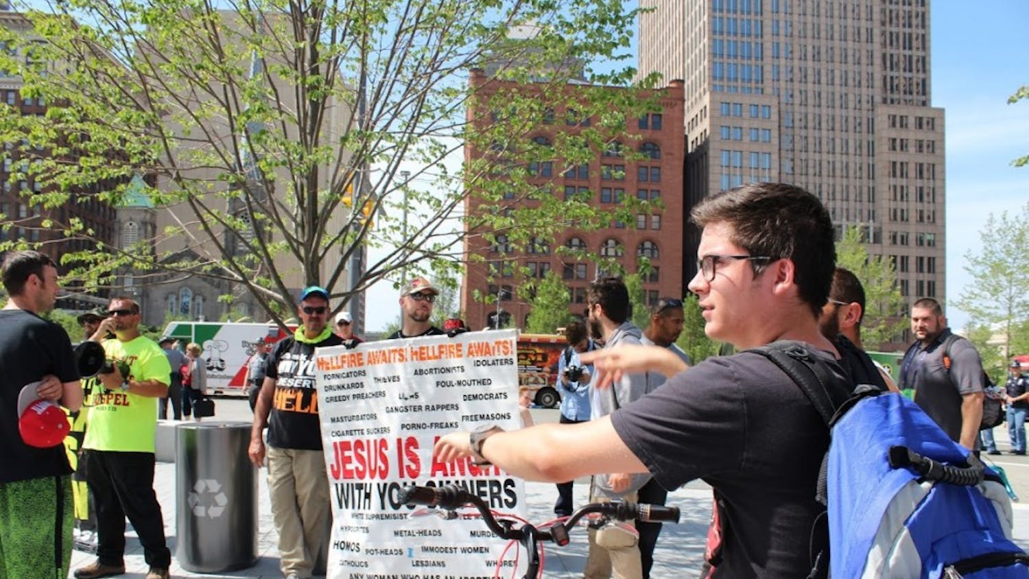 Brett Mills of Cleveland, 18, begins talking back to religious demonstrators and challenging them on their statements.