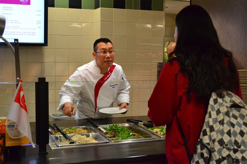 Chef Norman Leow from Sodexo, Singapore serves food during the cooking demonstration for the fall 2015 Sodexo Global Chef Program Tuesday morning at the IMU.