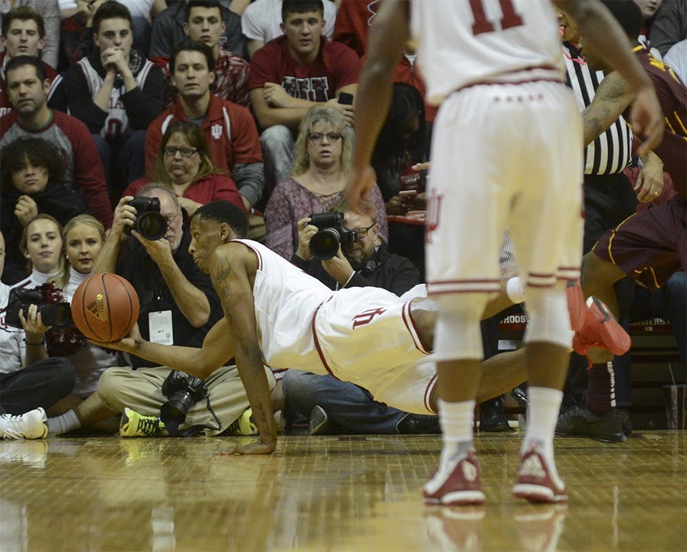 Junior foward Troy Williams attempts to save the ball from going out of bounds during the game against Minnesota on Saturday at Assembly Hall. The Hoosiers won 74-48.