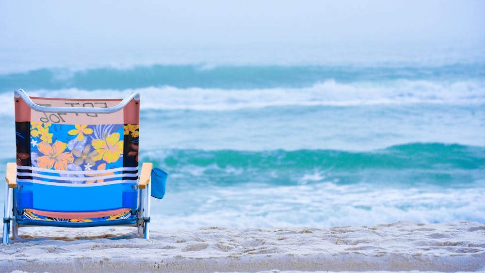 A beach chair rests on the sand. Travelers can expect a different experience than pre-coronavirus pandemic travel, according to Becky Liu-Lastres, IUPUI assistant professor of Tourism, Event and Sport Management, and Evan Jordan, IU assistant professor in the Department of Recreation, Park and Tourism Studies.