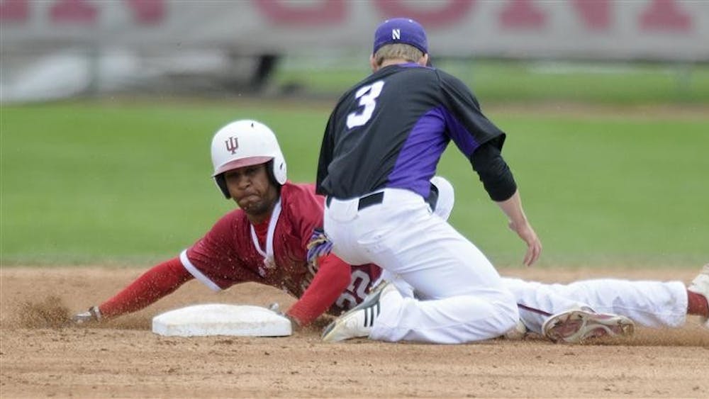 Sophomore outfielder Justin Cureton steals second base ahead of the tag from Northwestern's Trevor Stevens during IU's 8-2 win against Northwestern on Sunday at Sembower Field.
