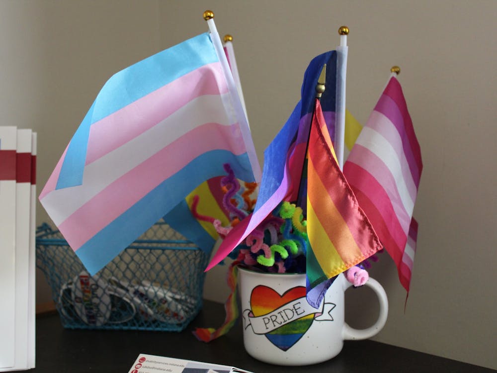 Two rainbow progress flags hangs against the windows in the front room of the LGBTQ+ Culture Center on Feb. 21, 2023. Brianna Ghey, a 16-year-old TikToker who was transgender, was stabbed in England on Feb. 11, 2023.