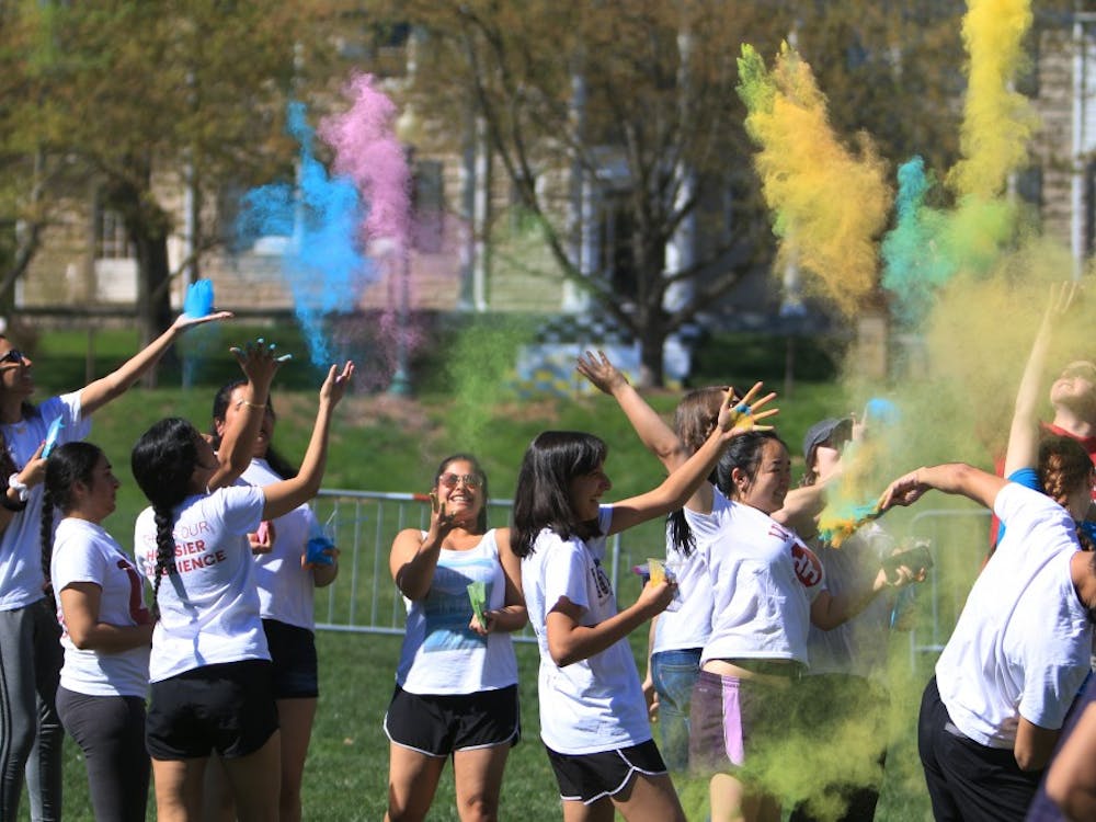 Students participate in the celebration of Holi on April 21 in Dunn Meadow. The event is also known as the festival of colors, and participants could throw different colored powders into the air and at their friends.