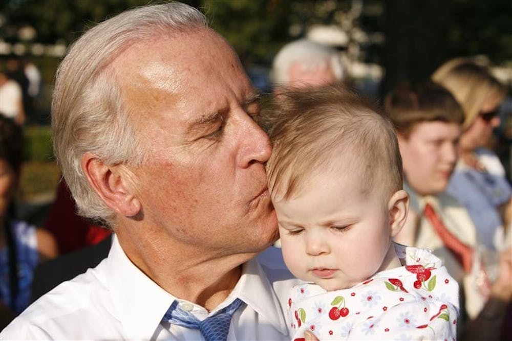 Democratic vice-presidential candidate Sen. Joe Biden kisses a supporter's baby following a rally Wednesday afternoon at Warder Park in Jeffersonville, Ind.