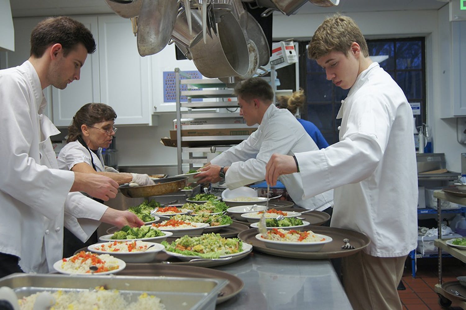 Evan Scholars Students serve a formal dinner at Kappa Alpha Theta Wednesday evening. Evans Scholars work as kitchen staff at a sorority house of their choice to supplement for their house not having a kitchen. This opportunity provides the Scholars with meals, and a paid job as well. 