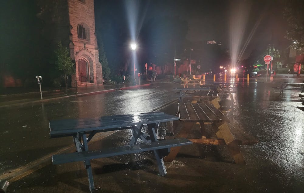 Picnic tables lie on Kirkwood Ave in Bloomington after being displaced by floodwaters Friday night. Bloomington Fire Department Deputy Chief Jayme Washel spoke with the Indiana Daily Student about flood safety Saturday.